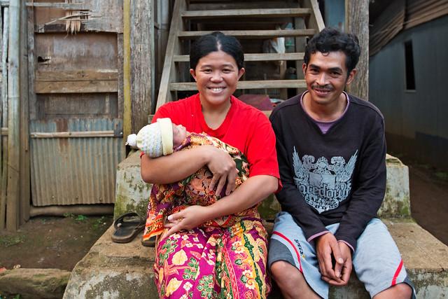 smiling couple with baby