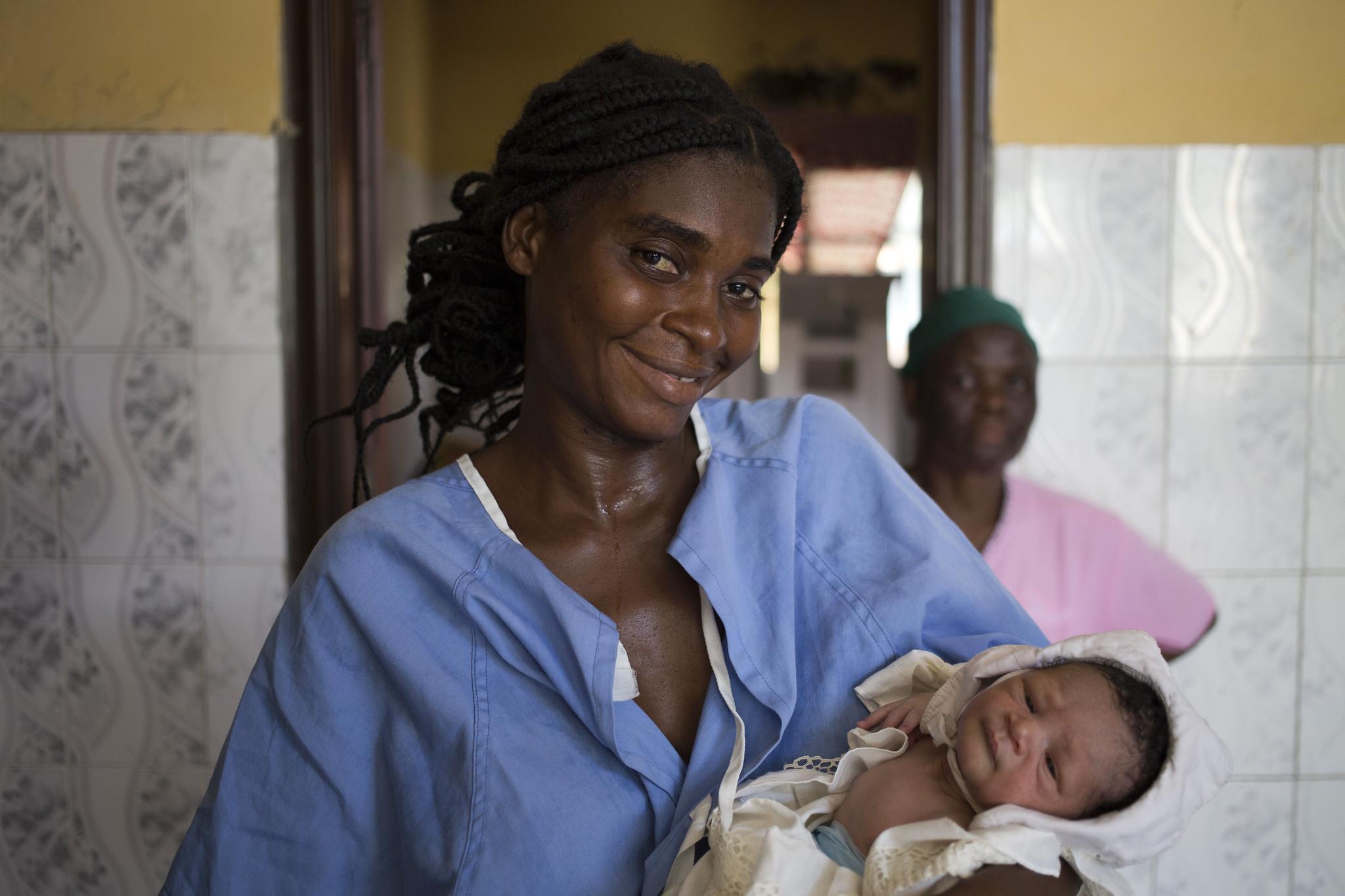 Nurse holding baby.