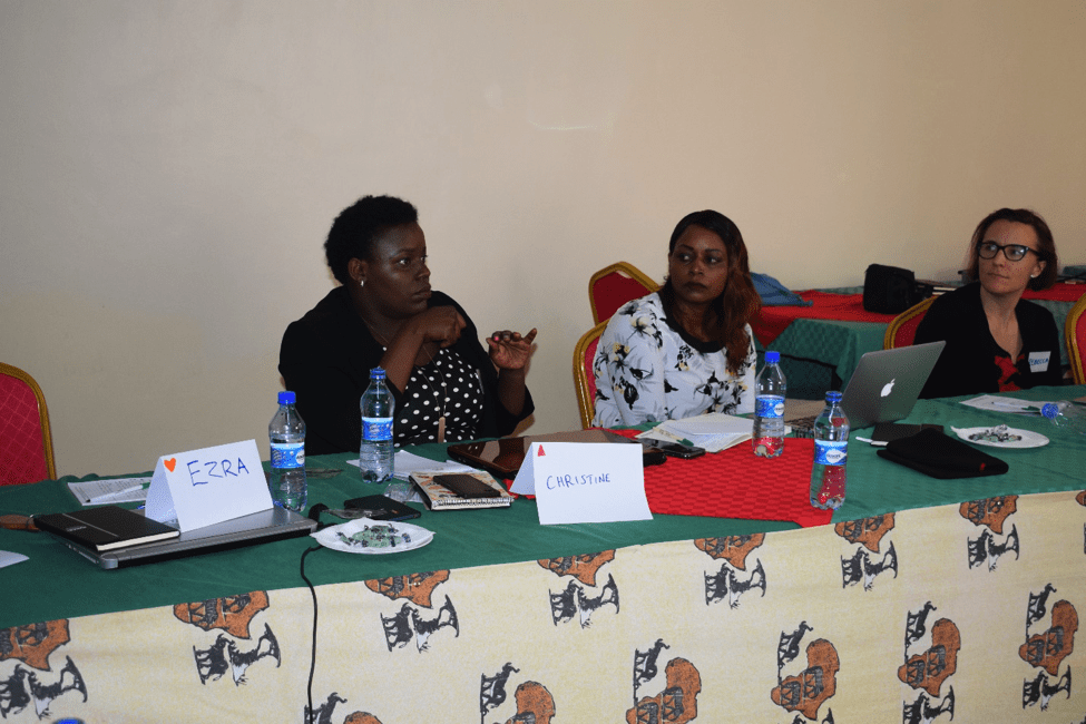 Three women sitting at table during discussion