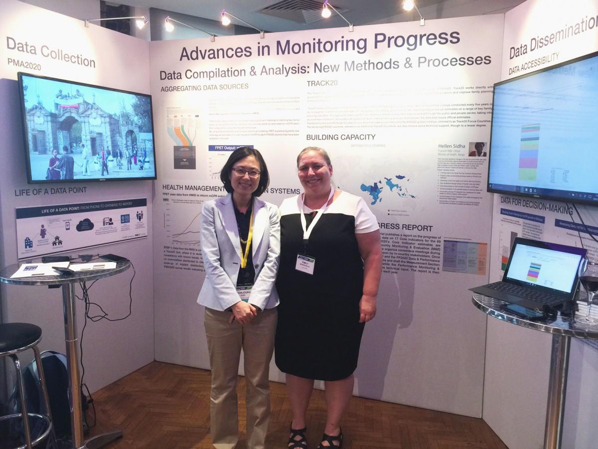 Two women standing at conference booth