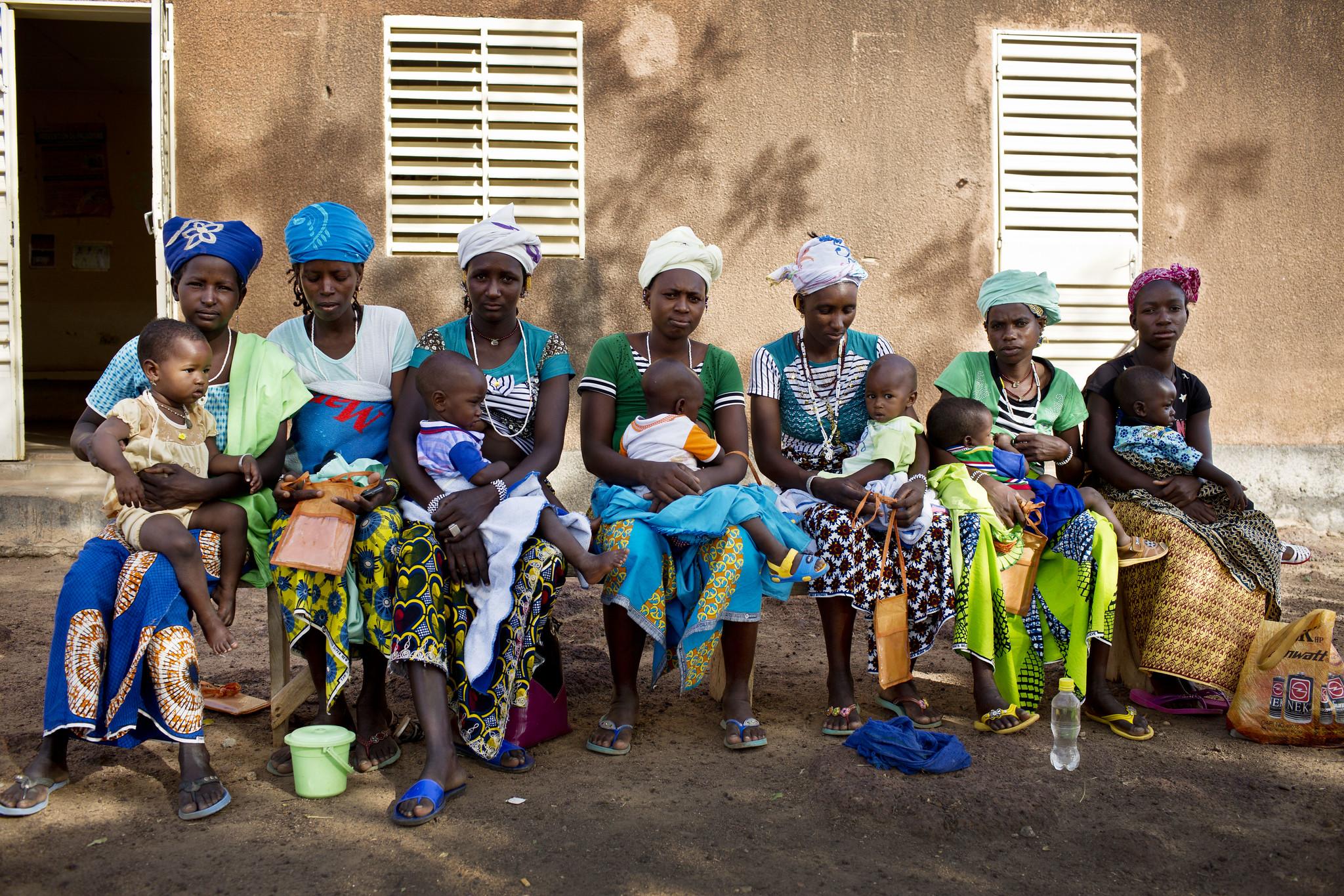 Group of women sitting together with their children on their laps