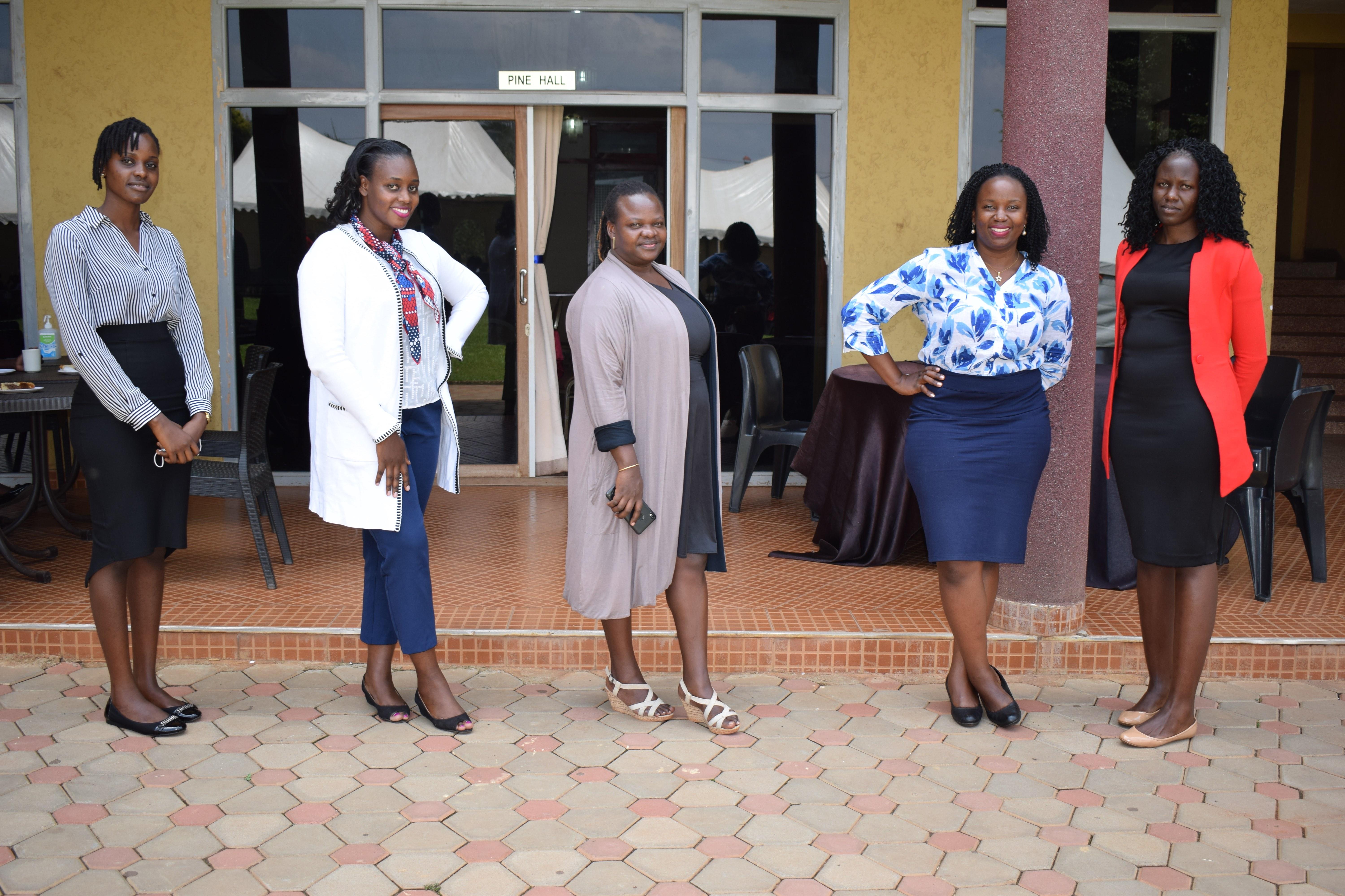 Five business dressed Ugandan women standing together